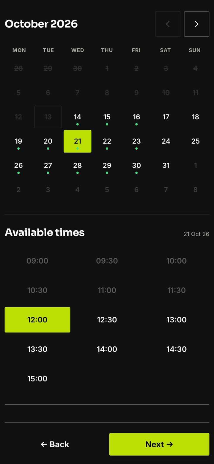 A booking page on a phone with a month calendar, Wednesday 21 October chosen, morning times greyed out as unavailable and 12:00 selected